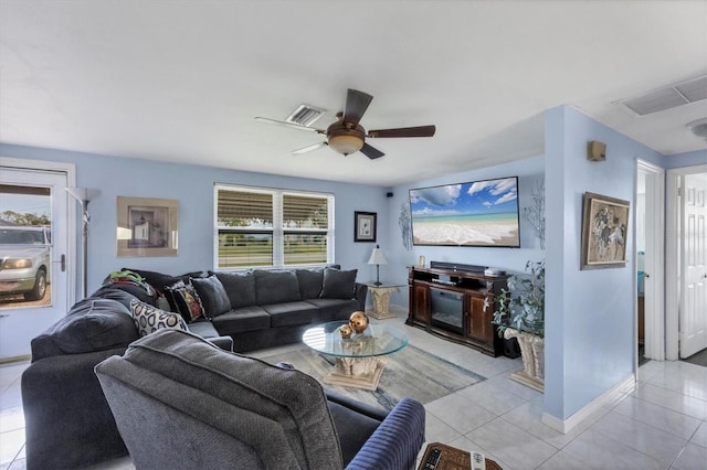 tiled living room featuring ceiling fan