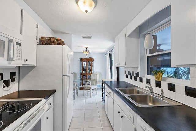 kitchen with white appliances, decorative light fixtures, tasteful backsplash, white cabinetry, and sink