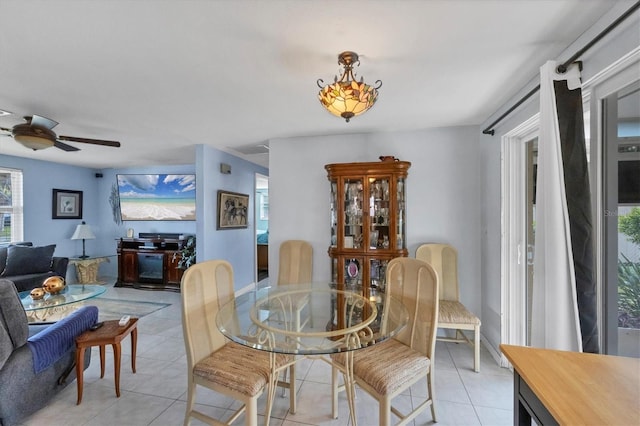 tiled dining area with ceiling fan