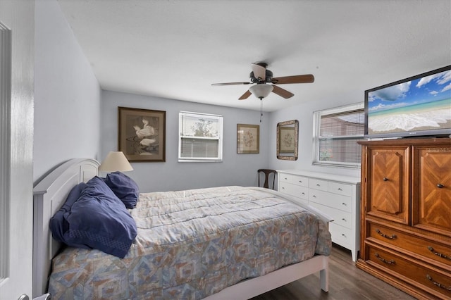 bedroom with ceiling fan and dark hardwood / wood-style floors