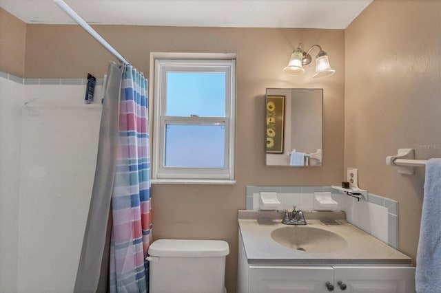 bathroom with toilet, vanity, a chandelier, and walk in shower