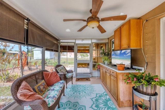 sunroom featuring ceiling fan