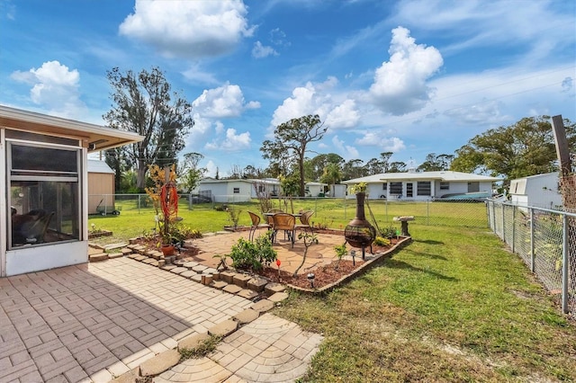 view of yard featuring a fire pit and a patio area