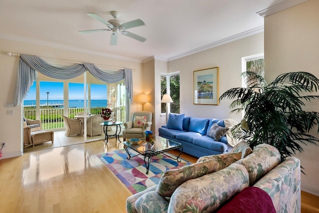 living room with light hardwood / wood-style floors, ceiling fan, ornamental molding, and a water view