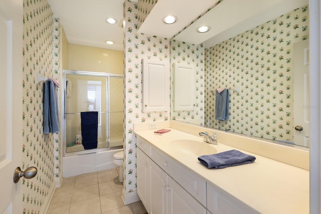 full bathroom with tile patterned floors, vanity, toilet, and combined bath / shower with glass door