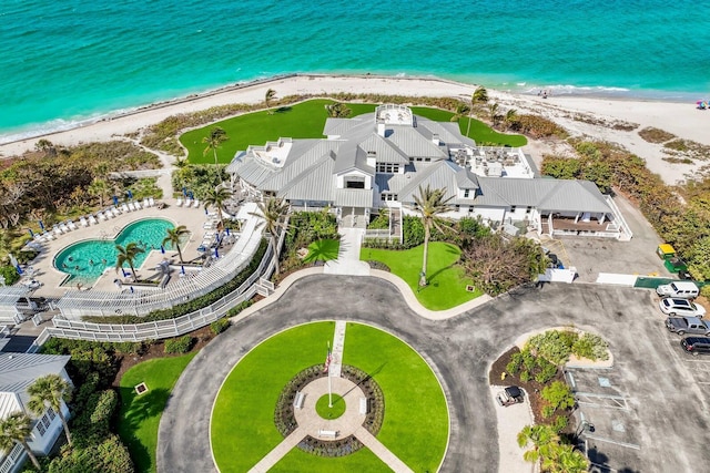 aerial view with a water view and a beach view