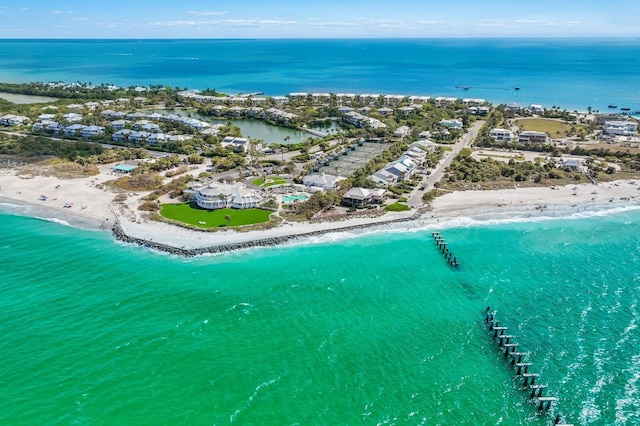 birds eye view of property featuring a water view and a beach view