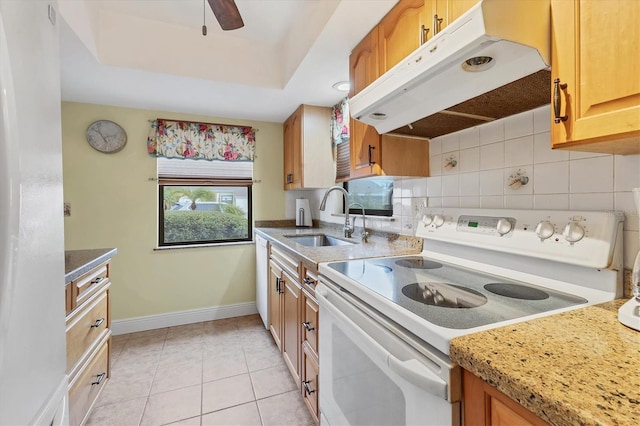 kitchen featuring electric stove, sink, light tile patterned floors, ceiling fan, and a raised ceiling