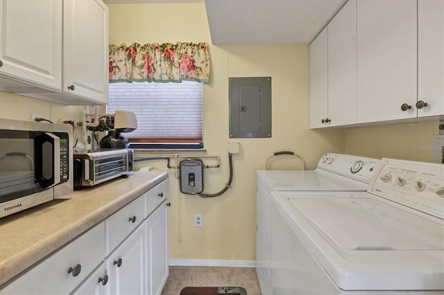 laundry room with cabinets, washer and dryer, light tile patterned floors, and electric panel