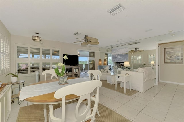 dining space with ceiling fan and light tile patterned floors