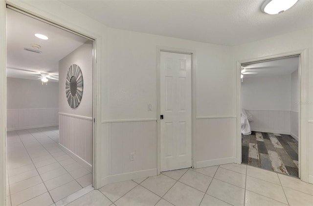 corridor featuring light tile patterned floors