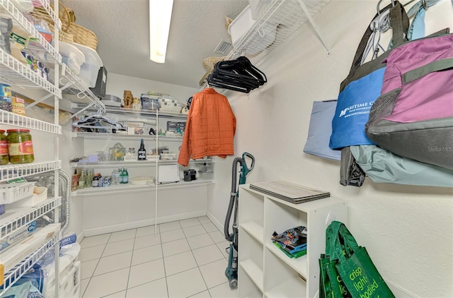 spacious closet featuring light tile patterned floors