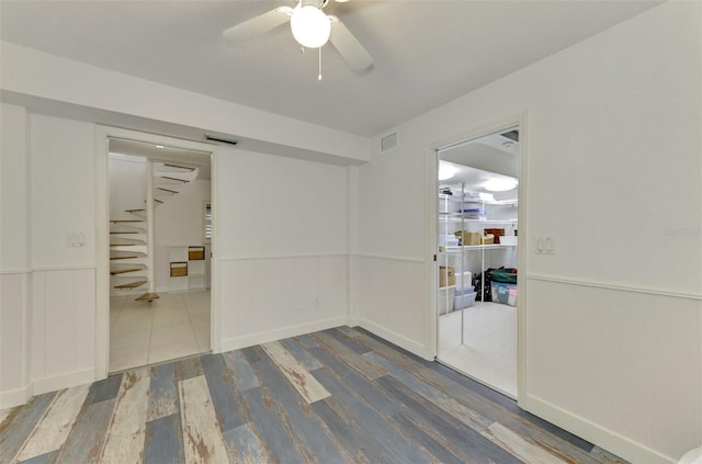 empty room featuring ceiling fan and hardwood / wood-style flooring