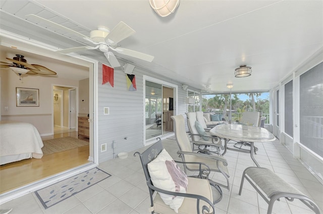 sunroom / solarium featuring ceiling fan