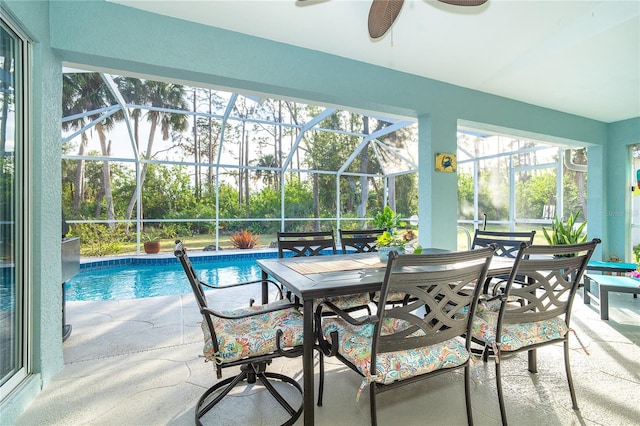 sunroom featuring ceiling fan, a swimming pool, and plenty of natural light