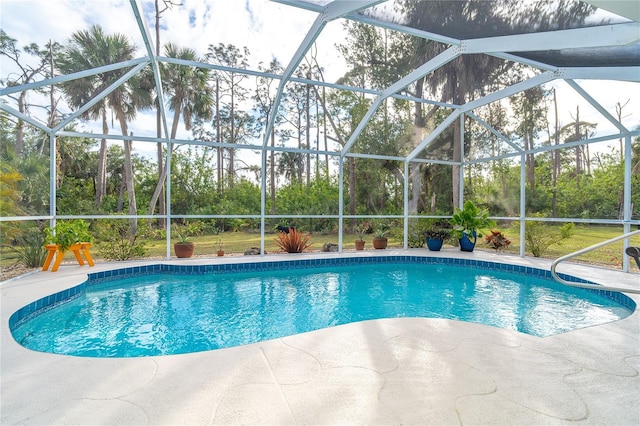 view of pool with a patio and glass enclosure