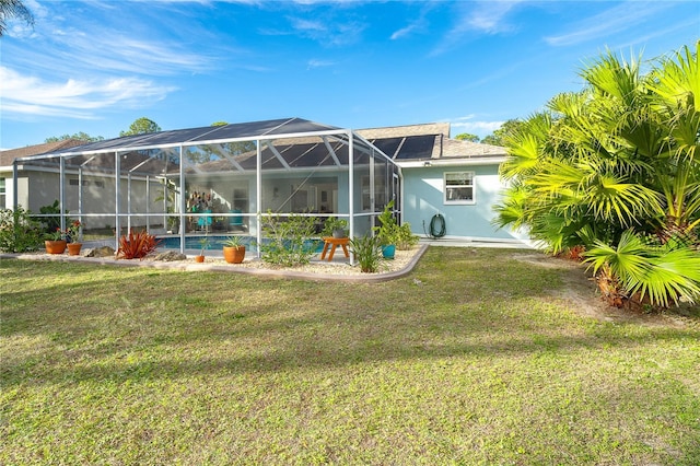 back of property with a lanai and a lawn