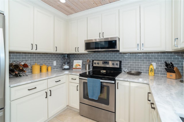 kitchen with decorative backsplash, white cabinetry, and appliances with stainless steel finishes