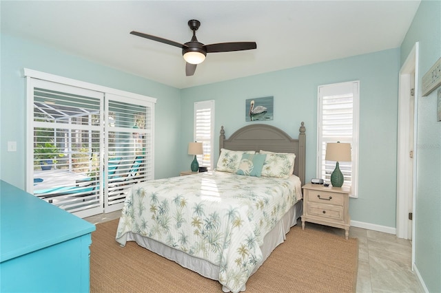 bedroom with multiple windows, ceiling fan, and access to outside