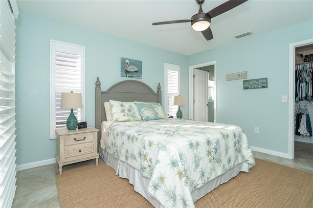 bedroom with ceiling fan, a spacious closet, and a closet