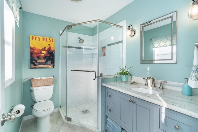 bathroom with toilet, tile patterned floors, a shower with shower door, and vanity