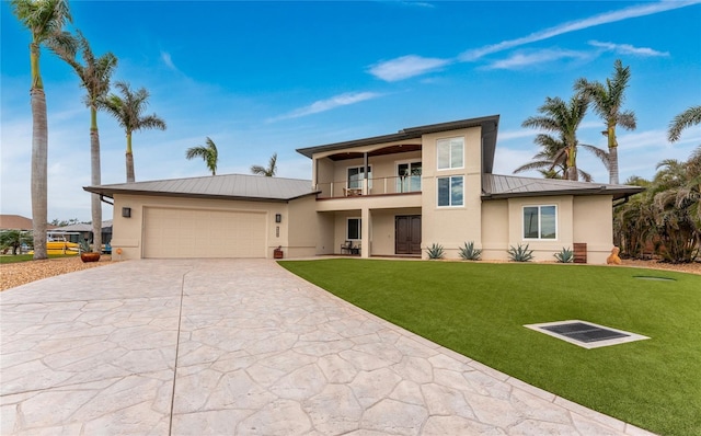 view of front facade with a front lawn, a garage, and a balcony