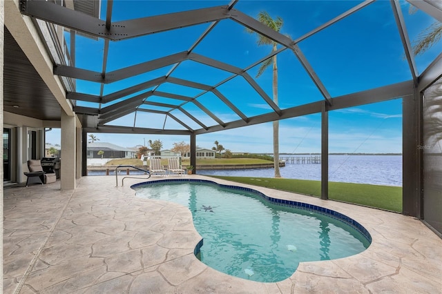 view of pool with a lanai, a patio area, and a water view