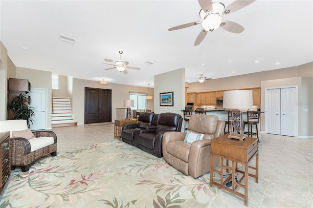 living room with ceiling fan and light tile patterned flooring