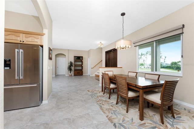 dining space featuring a notable chandelier