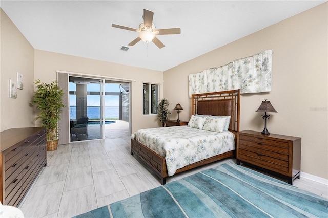 bedroom with ceiling fan, access to exterior, and a water view