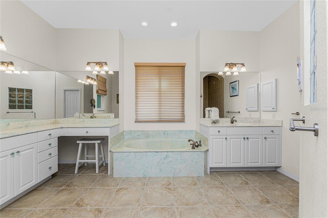 bathroom featuring tiled bath and vanity