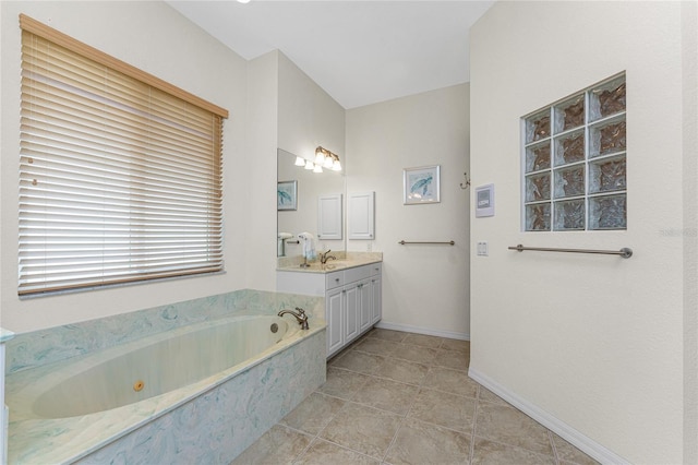 bathroom featuring tiled bath, tile patterned floors, and vanity