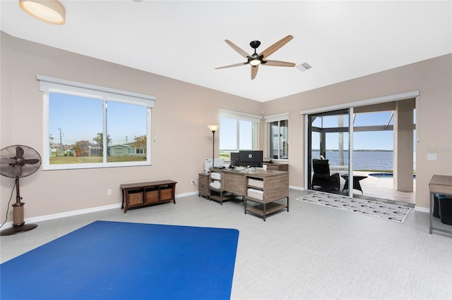 tiled home office featuring ceiling fan