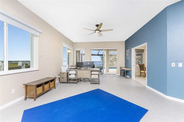 interior space with ceiling fan and light tile patterned flooring