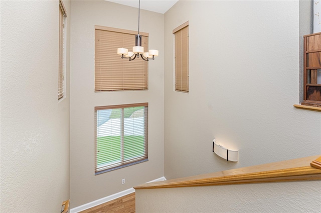 stairway featuring a notable chandelier and hardwood / wood-style floors