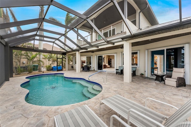 view of pool with a patio area, a lanai, and ceiling fan