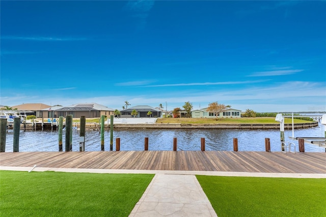 dock area with a water view and a lawn