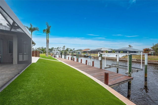 dock area featuring a water view and a yard