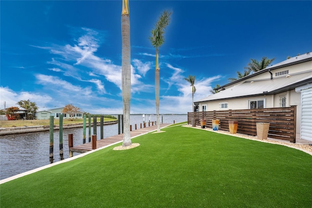 view of yard with a water view and a boat dock