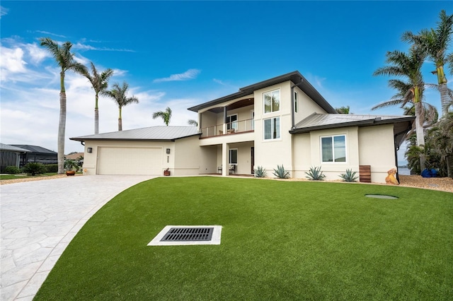 view of front of property with a front lawn, a garage, and a balcony