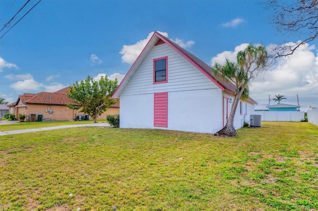 view of home's exterior with central AC unit and a lawn