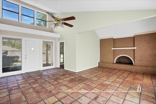 unfurnished living room featuring ceiling fan, plenty of natural light, and a fireplace