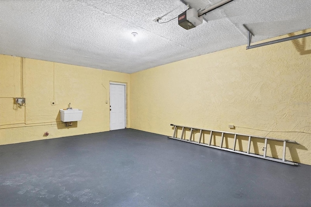 garage with a garage door opener and sink