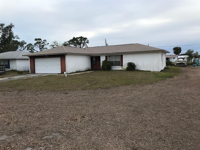 single story home featuring a garage and a front lawn