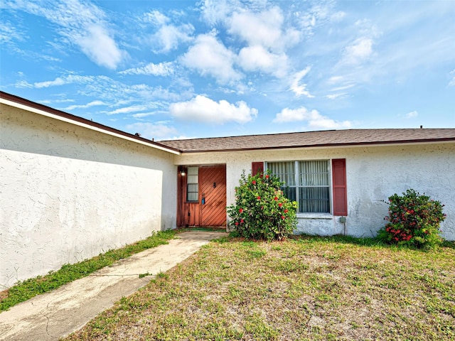 914 E 2nd St, Englewood, FL 34223 - property entrance with stucco siding and a yard