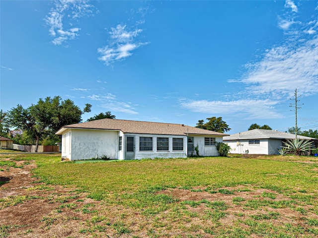914 E 2nd St, Englewood, FL 34223 - rear view of property featuring a yard and stucco siding