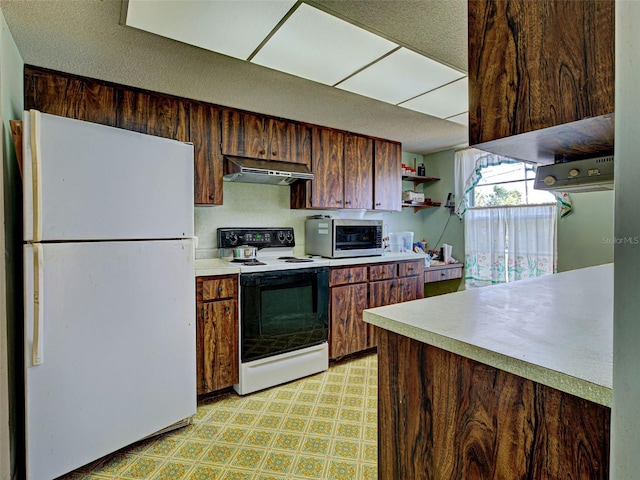 914 E 2nd St, Englewood, FL 34223 - kitchen with freestanding refrigerator, electric stove, stainless steel microwave, under cabinet range hood, and light floors