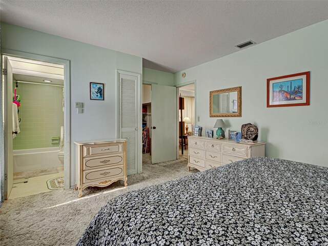 914 E 2nd St, Englewood, FL 34223 - carpeted bedroom with a textured ceiling, ensuite bathroom, and a closet