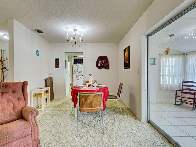 914 E 2nd St, Englewood, FL 34223 - carpeted dining space featuring a chandelier, a textured ceiling, and baseboards