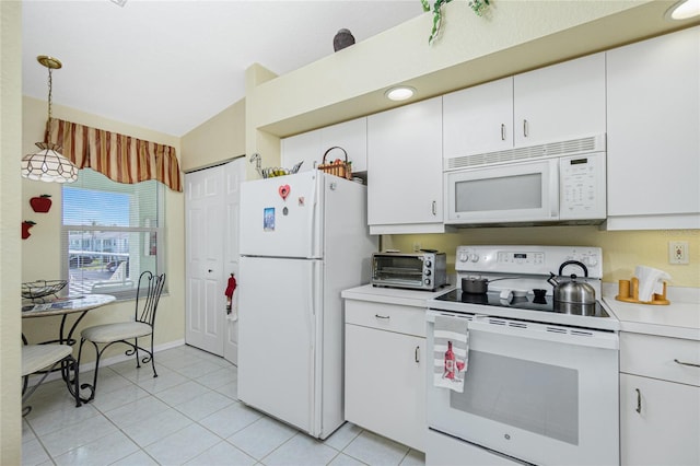 kitchen with hanging light fixtures, white cabinets, light tile patterned floors, white appliances, and lofted ceiling